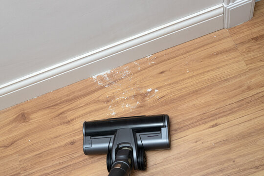 Vacuum cleaner brush cleaning the floor after renovation