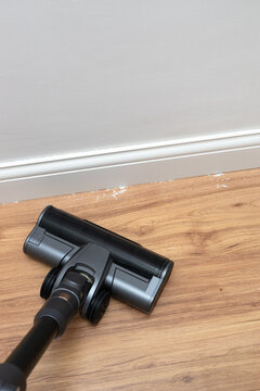 Vacuum cleaner brush cleaning the floor after renovation