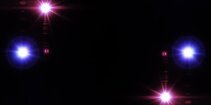 Spotlight on stage. Optical lens flares overlay shine effect on a black background.