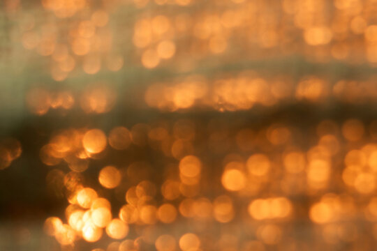 Featuring glowing orange and gold light spots. The soft, dreamy atmosphere