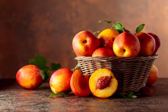 Fresh nectarines on a brown vintage background.