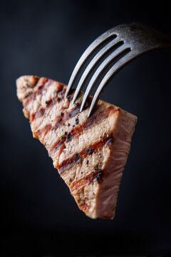Grilled Tuna Steak on Fork Macro Close Up Food Photography Dark Background Studio Shot Delicious Meal