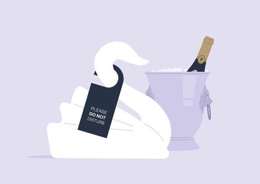 A sophisticated hotel room showcases a beautifully crafted swan towel resting beside a chilled bottle of champagne, exuding luxury and elegance.
