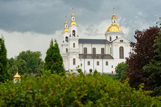 Vitebsk, Belarus, July 8, 2026. View of the Assumption Cathedral from the park on a cloudy summer evening.                               