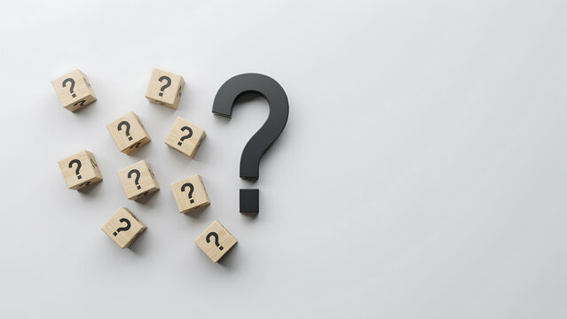 Wooden cubes with question marks arranged around a large black question mark icon question solution confusion information business strategy research decision thinking learning knowledge