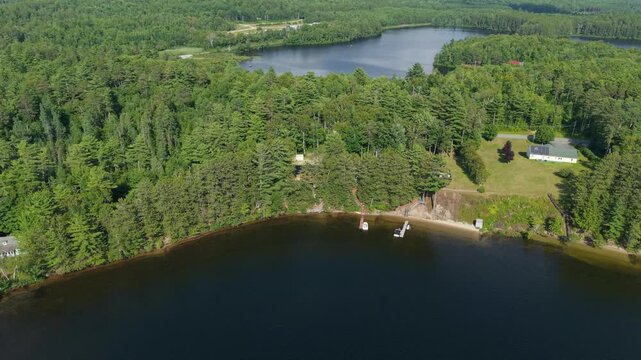 Aerial view of lakeshore cottages with docks and boats