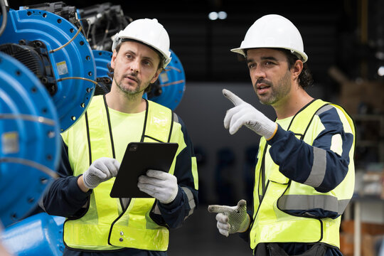 Robotics industry, training and development. Team of male engineer using digital tablet inspecting and connect to robotics arm system for testing and development solutions