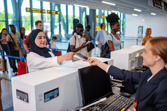 Woman submitting passport for check-in at airport terminal