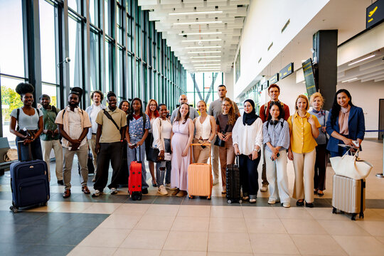 Diverse group of people standing in modern airport terminal