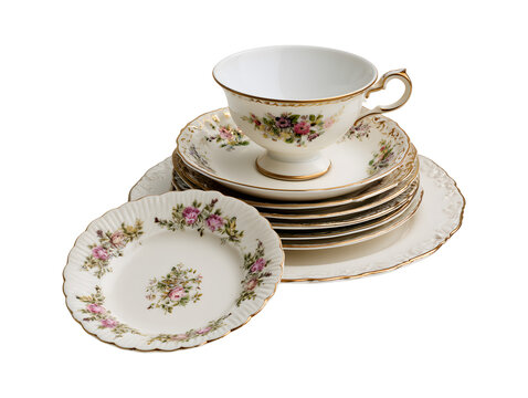 Vintage porcelain teacup saucer and stack of floral plates isolated on transparent or white background, png