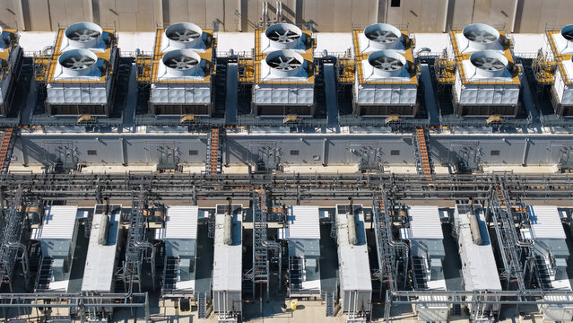 Aerial view of industrial cooling towers and HVAC systems with complex piping on data center infrastructure in Columbus, Ohio, United States.