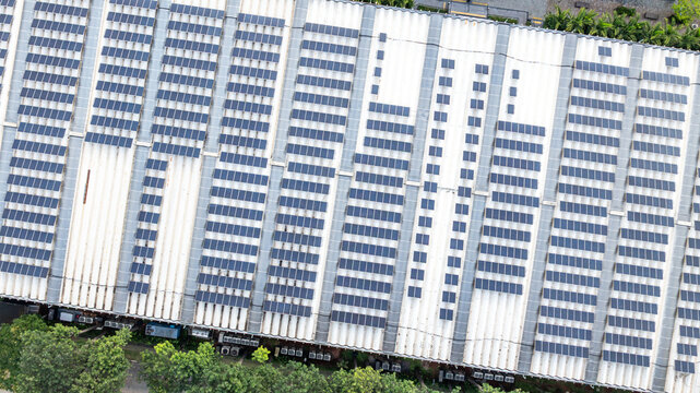 Aerial view of a large scale solar power plant with rows of solar panels on a rooftop, representing renewable energy at the Mercado Livre headquarters in Osasco, State of Sao Paulo, Brazil.