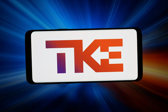 Stuttgart, Germany - 07-20-2026: In this photo illustration, the logo of German company TK Elevator GmbH (TKE) is displayed on a smartphone in front of abstract background on computer screen.