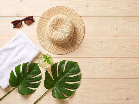 Stylish Summer Flat Lay with Sunglasses, Hat, and Lemonade on Wood