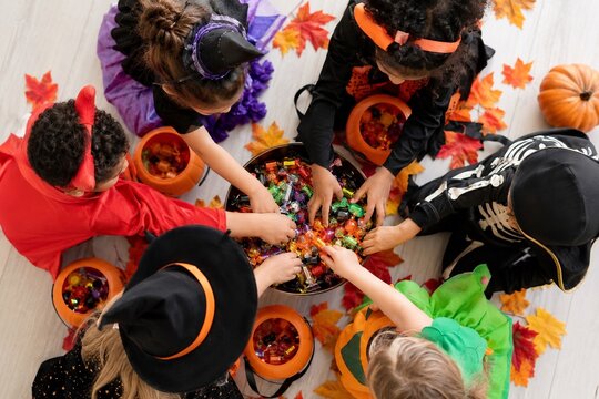 Children Sharing Halloween Candy in an Overhead Party View