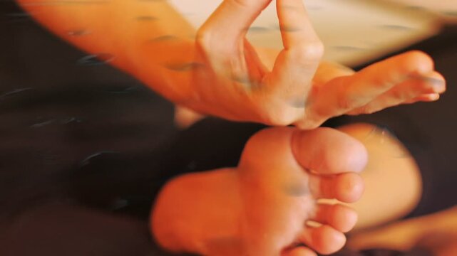 Translucent ripple appearing, hand approaching and forming pinching gesture over foot to calm