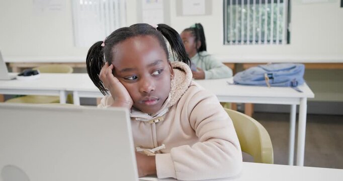 African girls in class hearing sound front girl resting leaning ignoring laptop rear with tablet