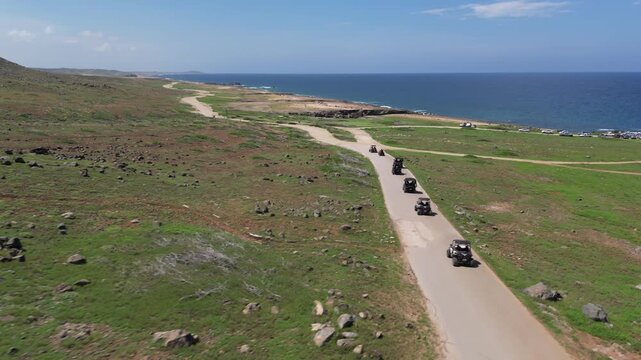 ATVs Riding Along Coastal Desert Road, Aruba &ndash; Aerial Drone View