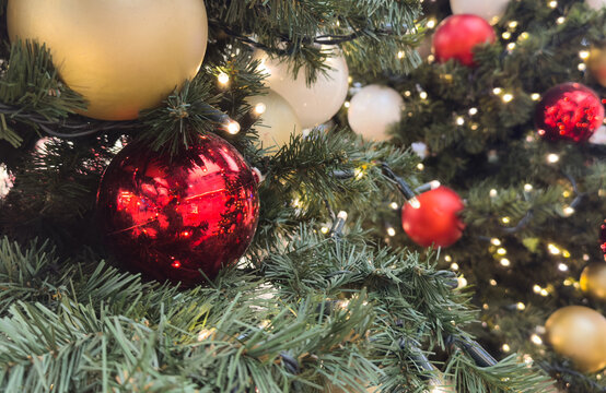Festive holiday decorations featuring cozy Christmas lights, ornaments, and pine branches creating a warm, nostalgic winter ambiance perfect for seasonal celebrations and winter-themed visuals.