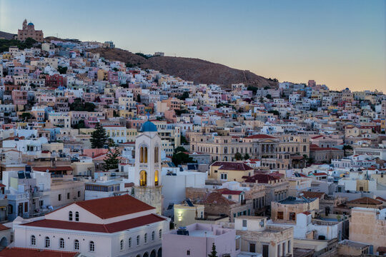 Neoclassical Landmark and Blue‑Domed Church Overlooking Ermoupoli&rsquo;s Dense Hillside