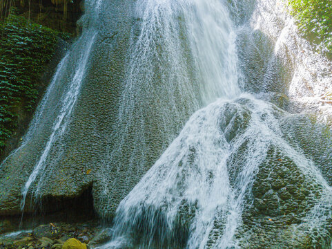 Majestic view of Embon Waterfall and river stream scenery at Pasie Raya, Aceh Jaya, Indonesia