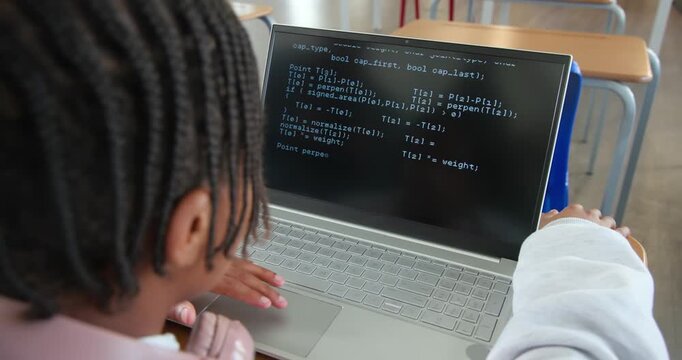 African youth male leaning in, using trackpad, reviewing code on laptop at school desk, copy space