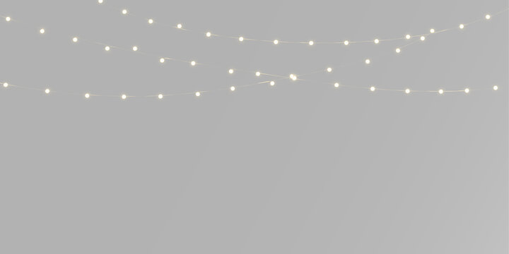 Glowing garland with warm yellow lights, tiny golden bulbs and elegant hanging Christmas strings