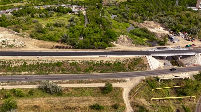 Road and bridge under repair top view aerial perspective, highway construction equipment and infrastructure renovation concept