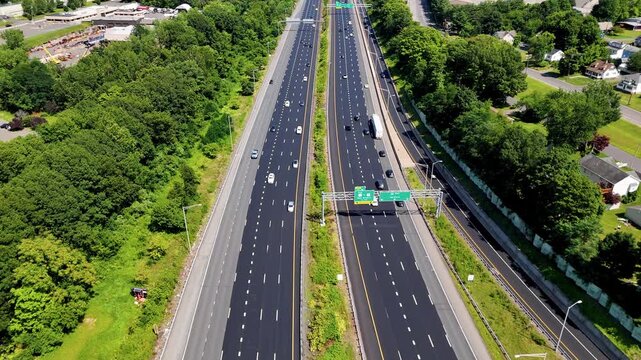 Heavy rush hour traffic moving along a busy highway with dense vehicle flow during peak commuting time. Ideal for transportation, urban mobility, congestion, commuting, and infrastructure concepts.