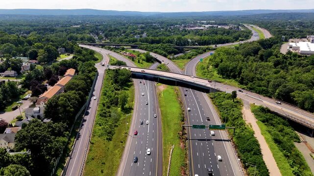 Aerial view of dense highway traffic with vehicles traveling during peak hours. Perfect for illustrating urban growth, transportation systems, commuting challenges, and road mobility.