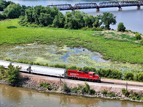 Savanna, Illinois May 22, 2026 Canadian Pacific 2326 Switching locomotive in bright red livery on mainline track along the Mississippi river with bridge in the distance