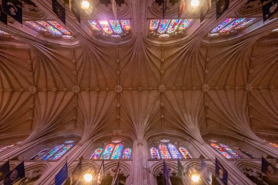 Washington, District of Columbia, United States - 06 May 2025: View of the intricate Gothic vaulted ceiling and colorful stained glass windows inside the Washington National Cathedral.
