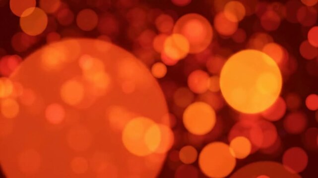 Abstract red and orange bokeh background, with floating light, particles and soft, glowing orbs