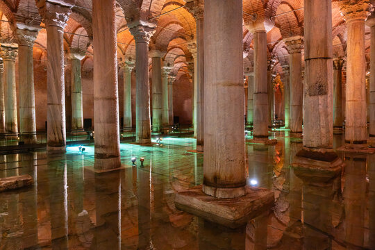 Fatih, Istanbul, Turkiye - 26 July 2026: View of the Basilica Cistern with its iconic marble columns reflected in the shallow water, illuminated by warm ambient lighting.