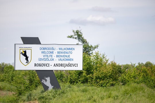 Welcome Sign for Rokovci Andrijasevci Village Roadside With Green Countryside Background