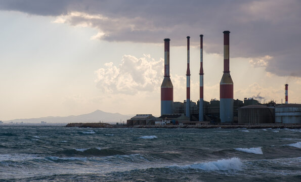 Industrial Electricity power plant with smokestacks releasing smoke, representing energy production, climate change, and environmental pollution. Dhekelia power station Cyprus
