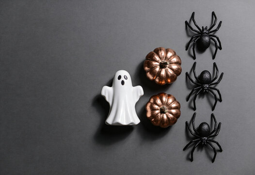 Halloween decor, white ghost figurine, metallic bronze pumpkins, black spiders, autumn holiday theme, spooky flat lay composition, october celebration concepts, creepy season decor elements.