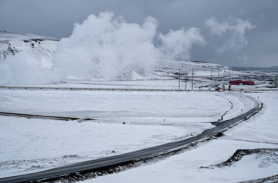 Krafla power plant creating renewable energy from geothermal steam in a snowy, volcanic iceland landscape