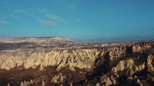 Aerial drone view of the unique rock formations and fairy chimneys in Cappadocia, Turkey. Cinematic landscape, nature, and geological wonders concept.