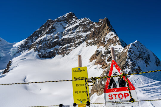 Risk of death warning sign at the edge of Glacier Plateau. Jungfraujoch, Canton of Bern, Switzerland. Translation: "risk of death".