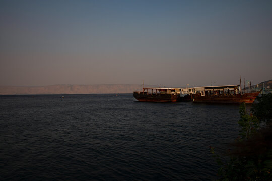 Beautiful Lakeside Marina in Tiberias with Traditional Wooden Cruise Boat Floating on the Sea of Galilee in Northern Israel