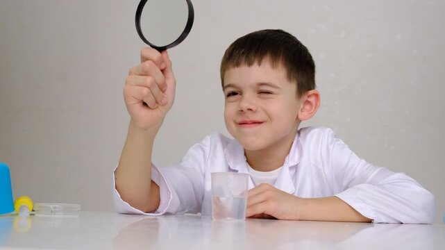 Laboratory examination of a child with test tubes, reagents and a microscope. Selective focus.