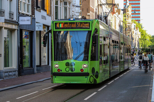 Green Amsterdam Tram Line 4 Traveling Through Historic City Center
