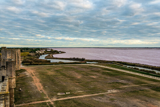 The pink salt lake and the medieval walled Old town of Aigues-Mortes, Camargue, France
