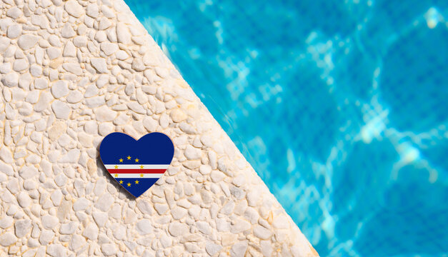 Cape Verde flag in the shape of a heart near the pool in the hotel. Holiday concept in Cape Verde