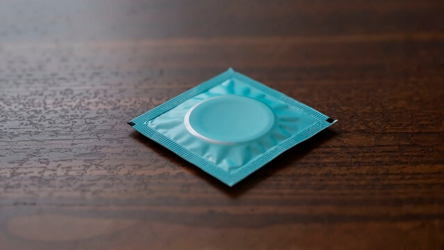 Condom packet on a wooden table