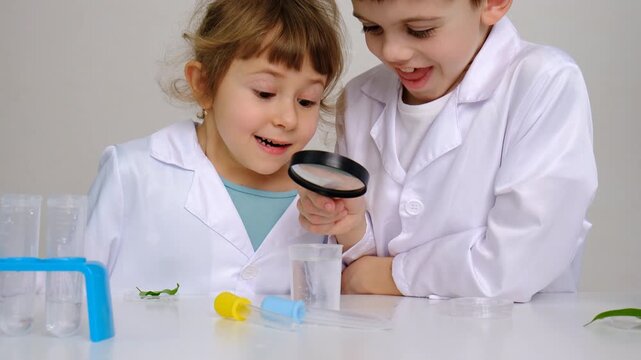 Laboratory examination of a child with test tubes, reagents and a microscope. Selective focus.