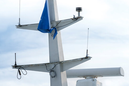 Ship mast with radar and antennas on a vessel, illustrating marine navigation technology and maritime communication systems.