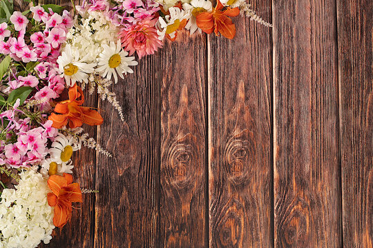 Advertising banner featuring beautiful garden flowers, chamomile, hydrangea, phlox, cherry blossoms and lilies, sunny summer postcard. Abstract floral composition and concept of elegant beauty,