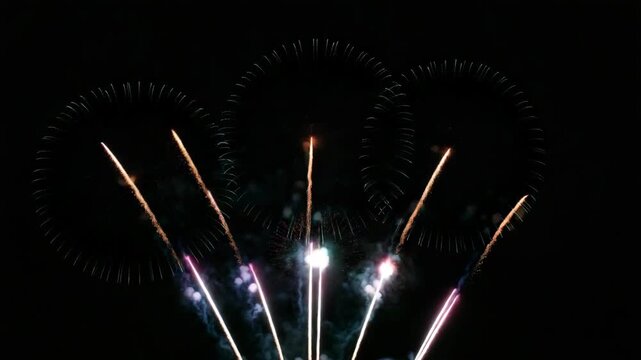 A stunning view of fireworks exploding in the sky during nighttime with a gradient background.